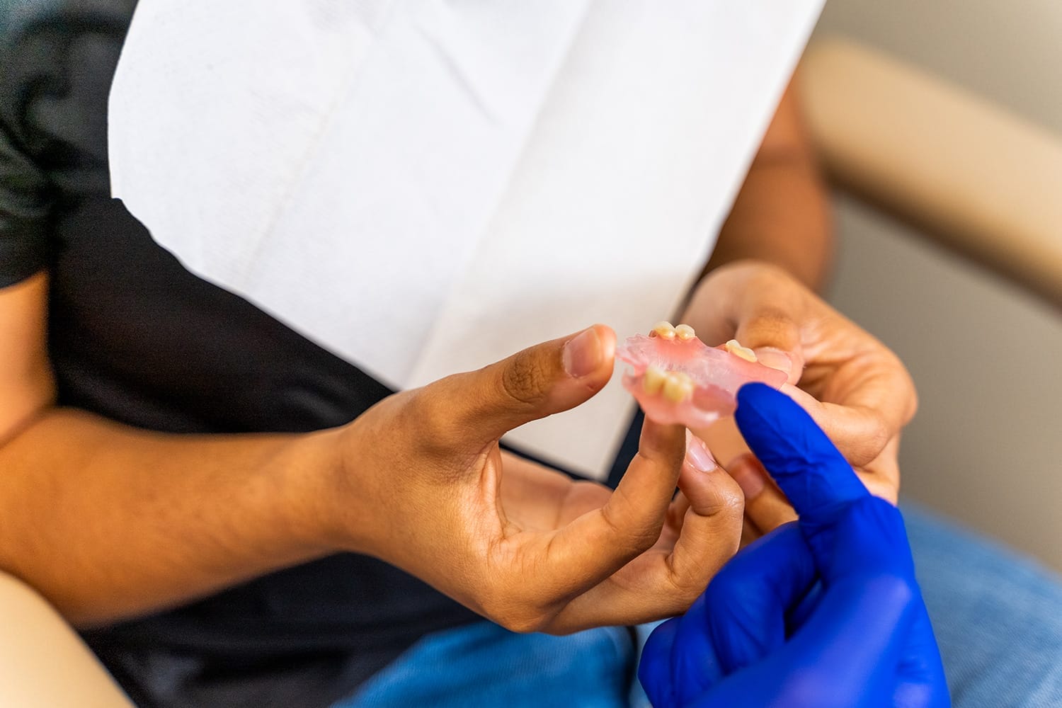 Showing-Dentures-to-Patient showing dentures to patient